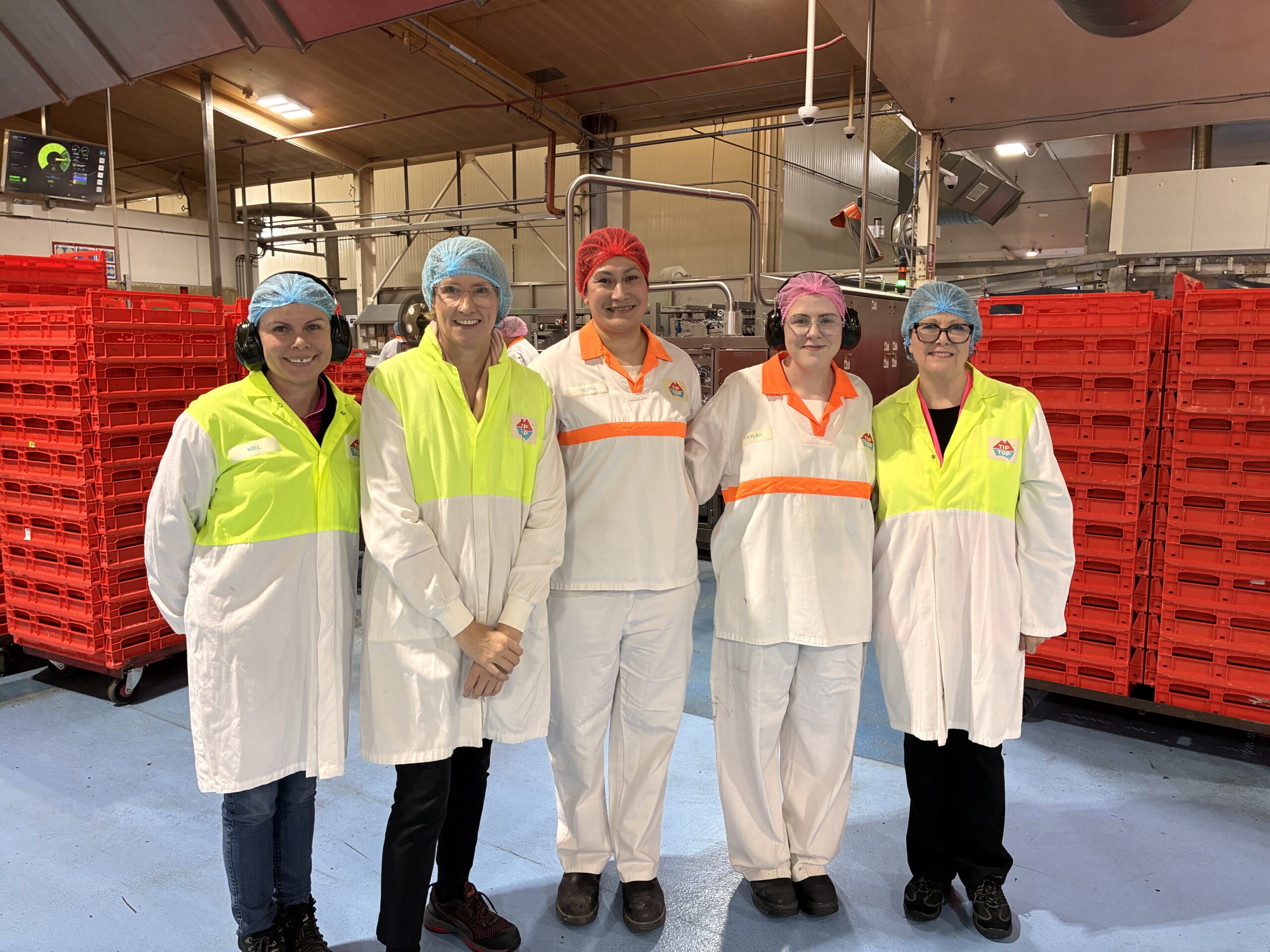 Five operations leaders from Tip Top Bakeries in hair nets and white coats